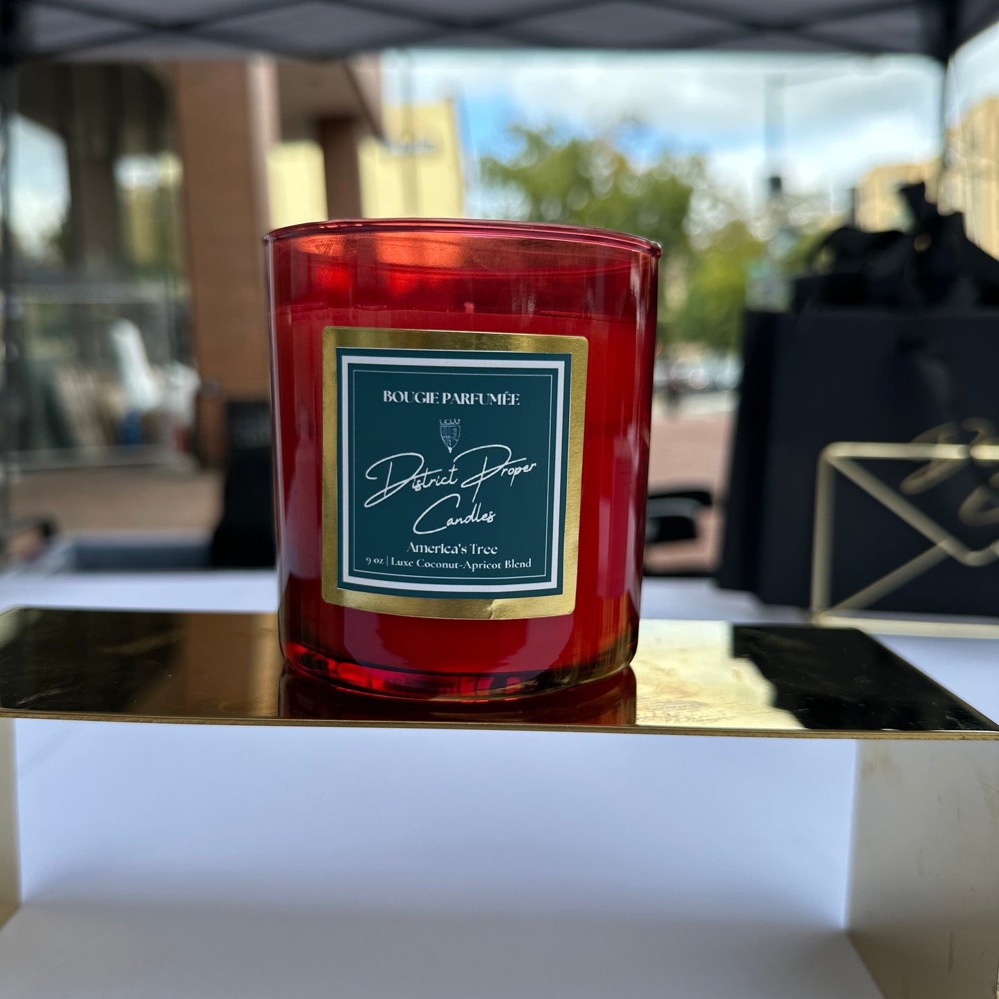 Candle in red holder. Smells like vibrant evergreen and luscious fruit.