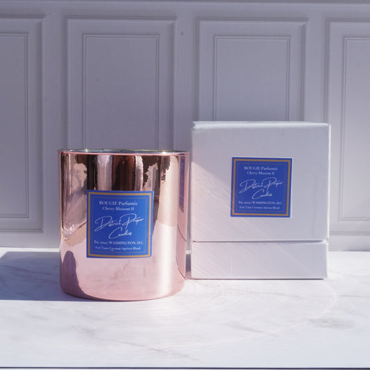 Gold candle with luxury packaging. Capitol Hill premium candle in coconut apricot wax. Smells like rich amber.