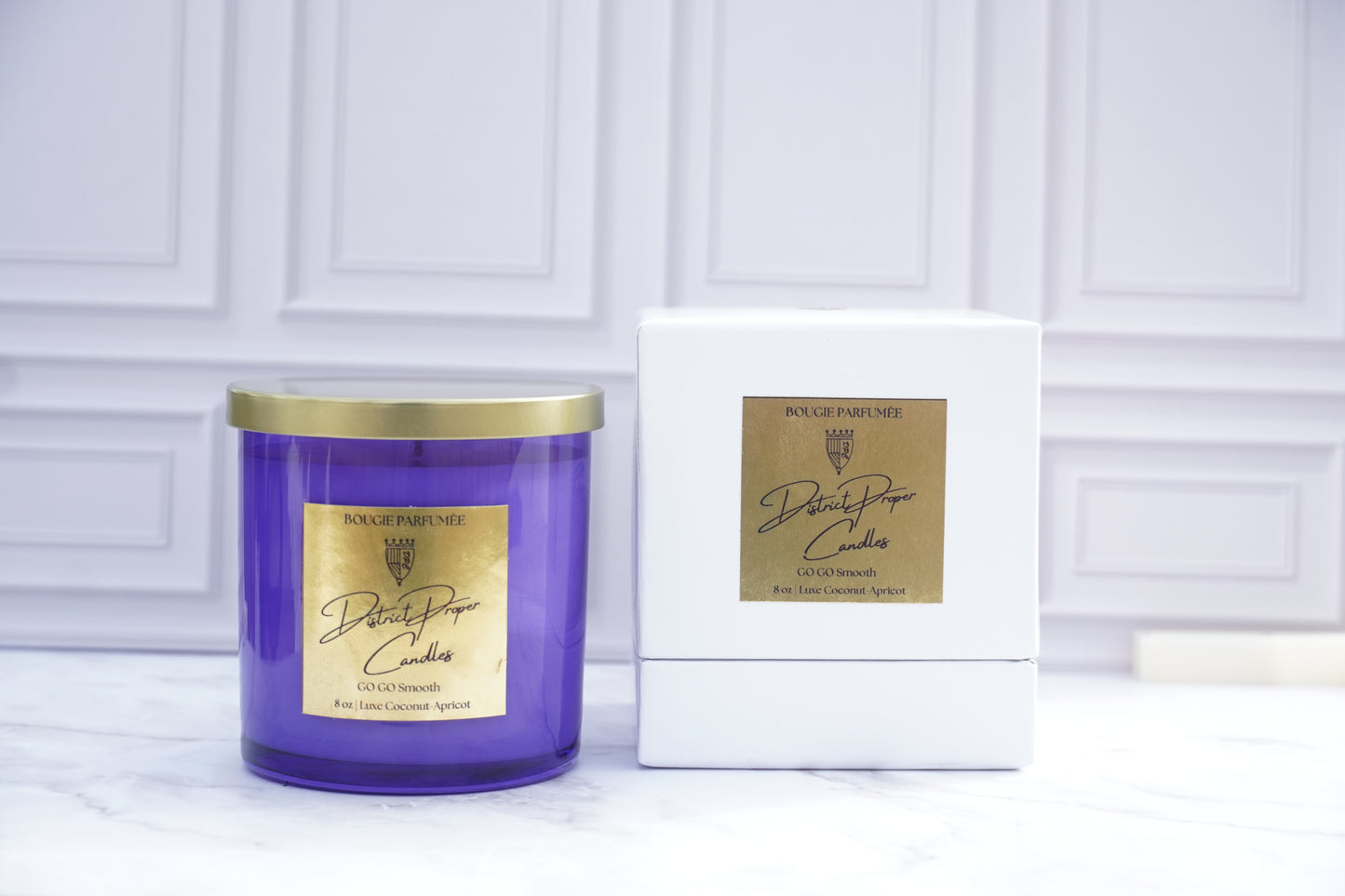 Purple candle with gold lid with label. Luxury packaging. Luxury handpoured candle. Smells like driftwood, rouge, and cashmere.