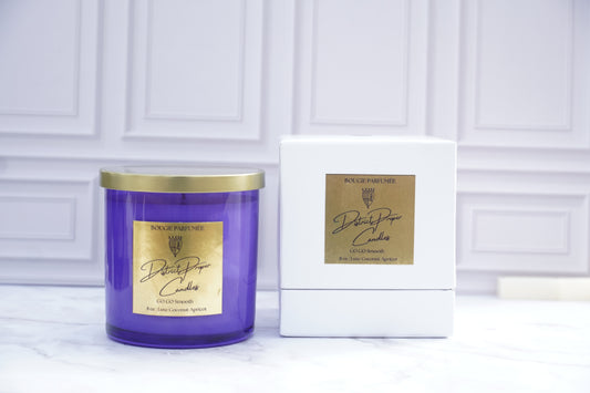 Purple candle with gold lid with label. Luxury packaging. Luxury handpoured candle. Smells like driftwood, rouge, and cashmere.
